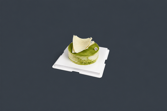 Miyabi Matcha Tiramisu with a green matcha top and sculpted ivory decoration on a white cake board