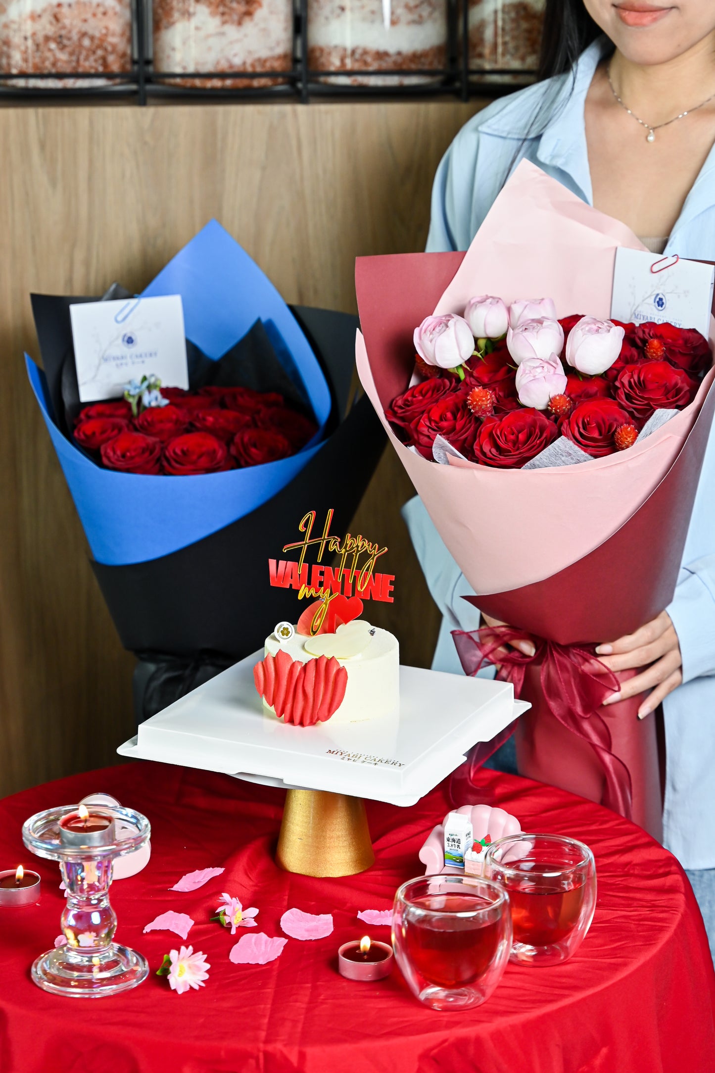 Bouquets of red roses, a small cake