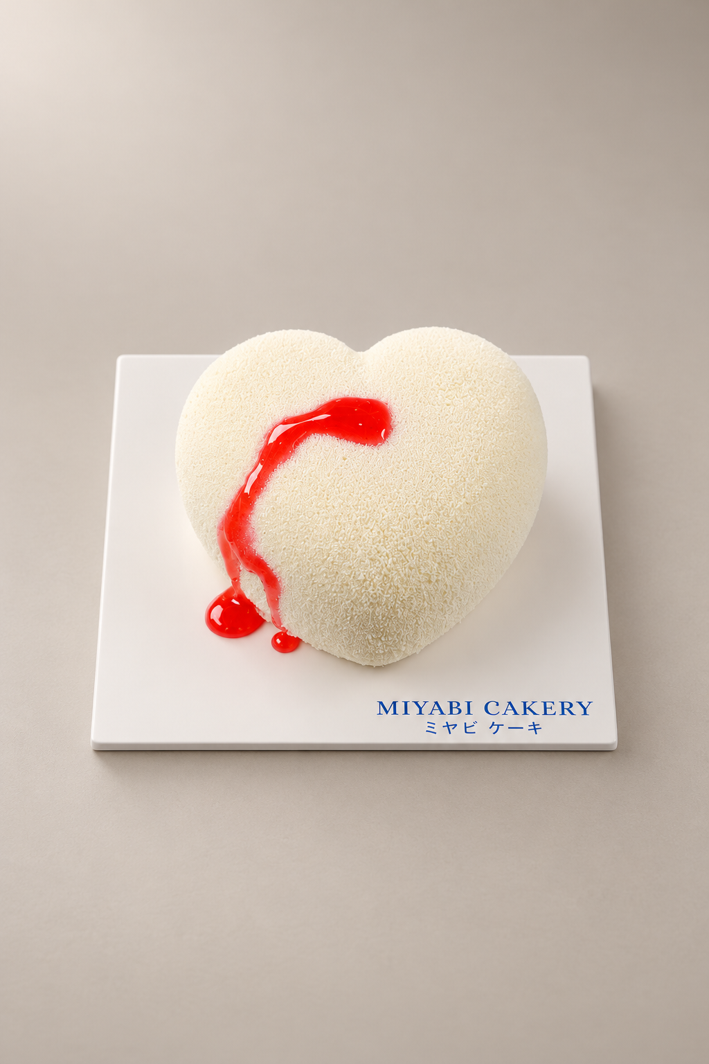 Bleeding Heart: white heart-shaped coconut mousse cake with red decoration. Non-alcoholic.