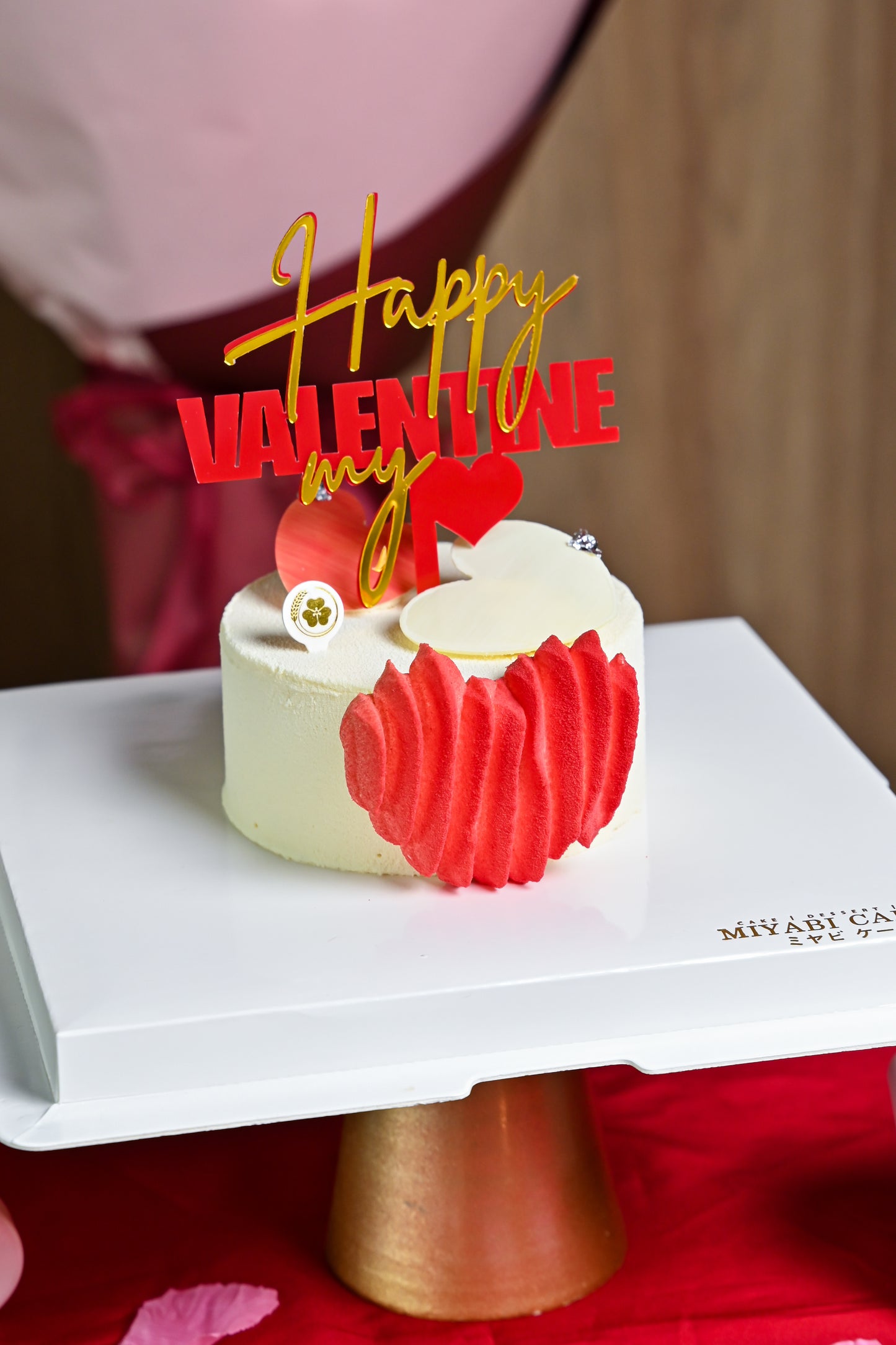 Elegant heart-shaped Valentine’s cake with festive topper, crafted by Miyabi Cakery in Kuala Lumpur.